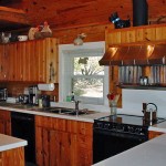 Cozy rustic kitchen with wooden cabinets and modern appliances.