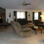 Cozy living room with recliner chairs and sofa set.