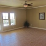 Empty room with tiled floor and ceiling fan.