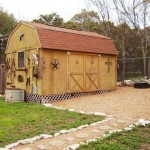 Rustic wooden barn with a red roof in a rural setting.