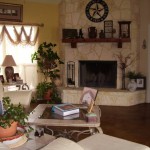 Cozy living room with fireplace and plants.
