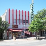 Historic theater with American flag outside.