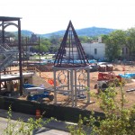 Construction site with triangular metal framework.