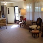 Cozy living room with vintage furniture and soft lighting.