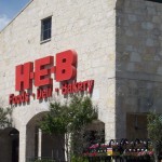 Storefront with H-E-B sign and entrance.