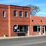 Red brick building on a sunny street.