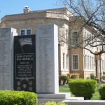 War memorial monument outside historic building.