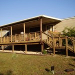 A wooden ramp and porch attached to a building.