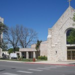 Stone church building under clear blue sky.