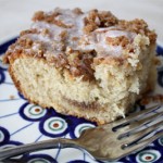 Slice of crumb cake on decorative plate.