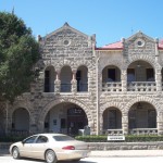 Historic stone building with arched windows.