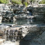 Natural rock pool with gentle waterfall.