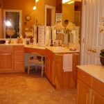 A cozy kitchen with wooden cabinets and warm lighting.