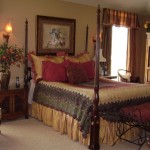 Elegant bedroom with a four-poster bed and warm lighting.