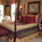 Cozy traditional bedroom with a wooden four-poster bed and warm-toned decor.