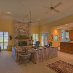 Cozy living room with a stone fireplace and warm lighting.