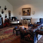 A cozy living room with floral furniture and a fireplace.